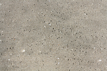 Worm holes in sand beach. Coastal porosity