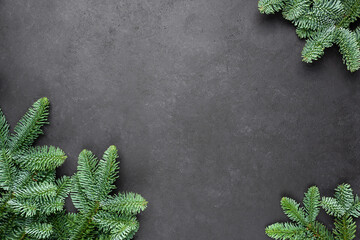 Christmas frame background with fir tree on black concrete background. Design mock up