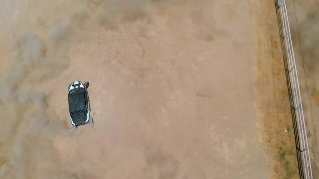 Birds Eye Drift of a Can Am drifting in dirt