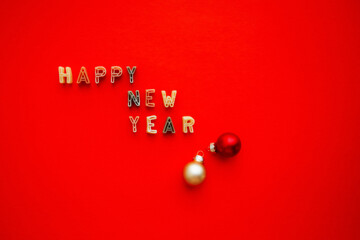 Happy New Year lettering on a bright red background with a copy of the space. Greeting card. The concept of the celebration. Paste of letters of the alphabet.