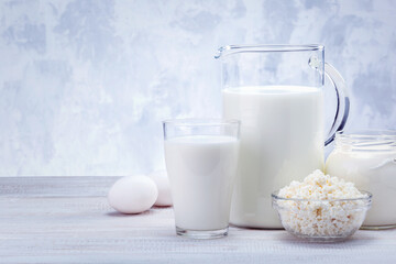 Assorted Dairy Product On White Wooden Table With Copy Space.