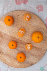 Fresh juicy clementine mandarins on wooden board 