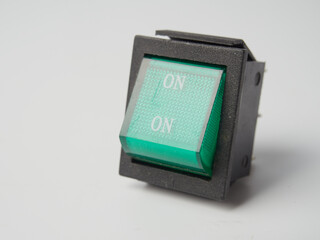 Small electronic tactile toggle push button switch with blue hat isolated on white background.