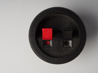 Small electronic tactile toggle push button switch with blue hat isolated on white background.