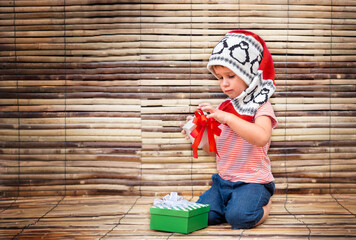 child with gift box on bamboo backround