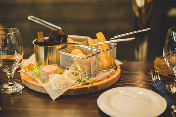 Dishes with different snacks on bar counter