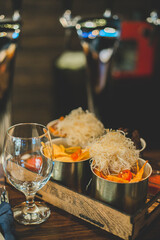 Dishes with different snacks on bar counter