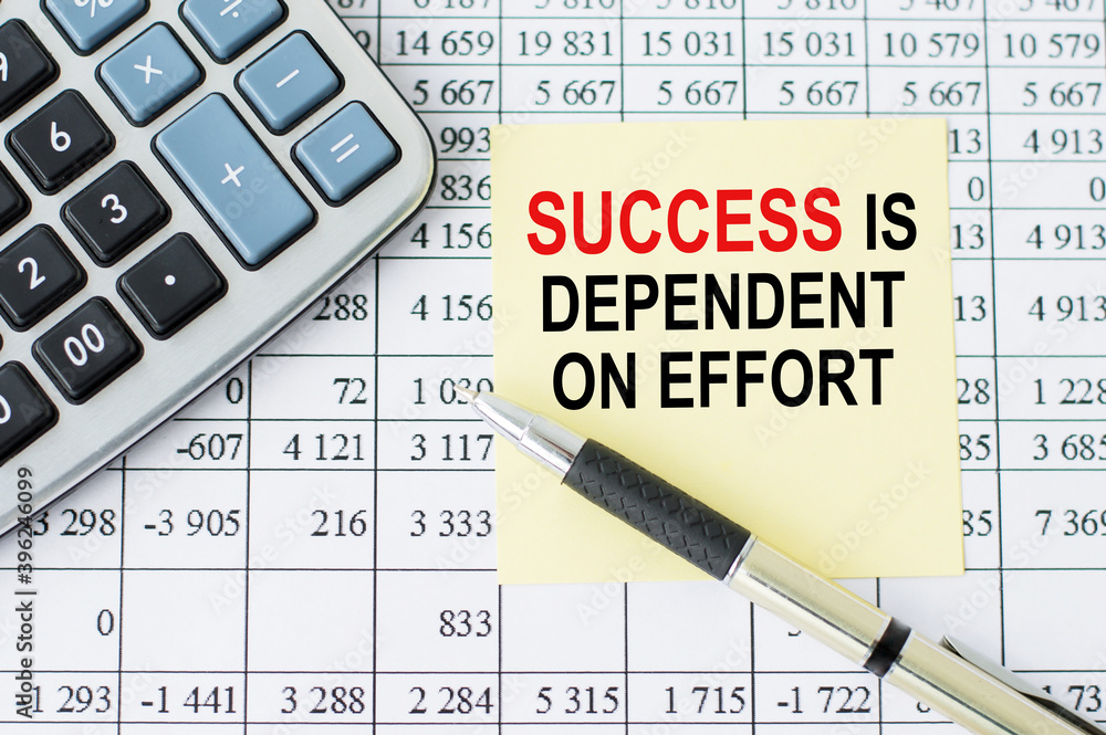 Poster on the table lies a calculator, pen and note paper with text success is dependent on effort on the n
