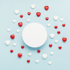 Valentine's Day holiday card. Red white small shiny hearts and empty frame on pastel blue background.