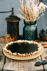 Chocolate cake made of loose dough on a wooden table. Sliced cake with caramel filling.