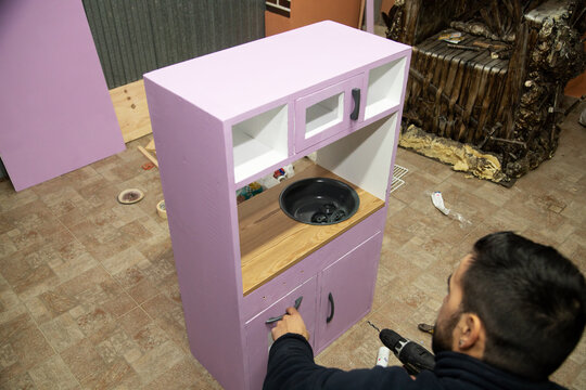 Man Creating Homemade Toy Kitchen