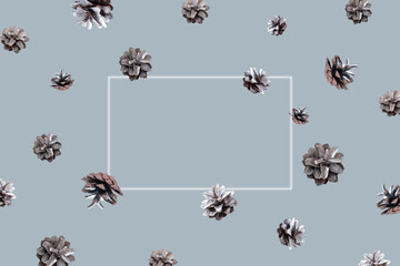 Hello winter concept. Winter pattern with flying silver pine cones and frame on blue background....