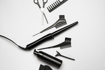 Set of hairdresser's tools on grey background