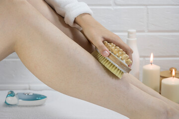 Exfoliation with a natural bristle brush. Dry brush massage. Preparing the skin for epilation. Strawberry legs, keratosis. Home skin and body care. SPA. Hairy legs. Beautiful slim female legs. 