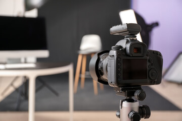 Modern camera and equipment in photo studio