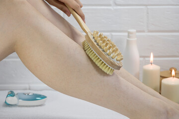 Exfoliation with a natural bristle brush. Dry brush massage. Preparing the skin for epilation....