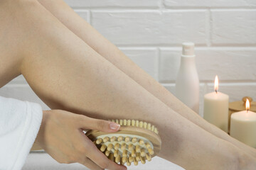 Dry brush massage. Preparing the skin for epilation. Exfoliation with a natural bristle brush. Strawberry legs, keratosis. Home skin and body care. SPA. Hairy legs. Beautiful slim female legs.