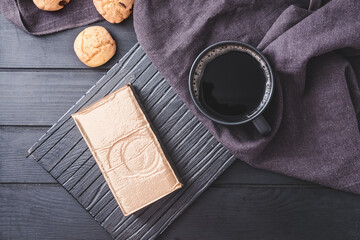 Pack and cup with coffee on wooden table