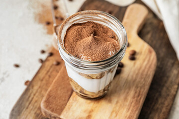 Sweet tasty tiramisu on table, closeup