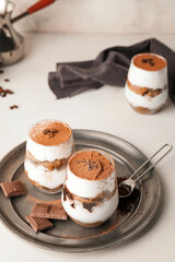 Sweet tasty tiramisu on table