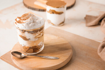 Sweet tasty tiramisu on table
