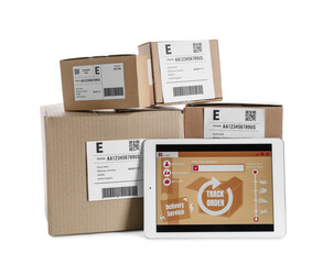 Tablet computer with open page of delivery service application and parcels on white background