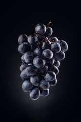 Dark grapes on a black background