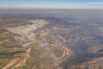Fototapeta na wymiar Aerial drone shot of Cap de Bou at Montserrat near Barcelona with morning fog