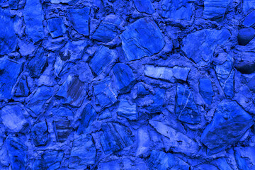 Abstract background of many large stones. Empty stone surface of blue color.