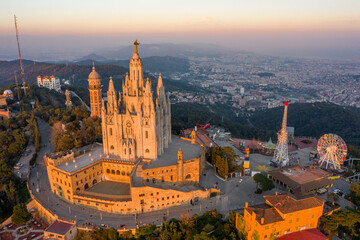 Aerial drone view of Basilica Sacred Heart on Mount Tibidabo near Barcelona during sunset golden...