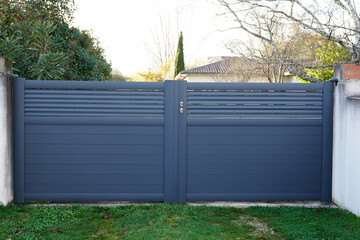 Aluminum steel grey metal gate house portal of suburb home