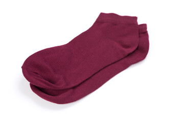 Pair of burgundy short socks on white background, top view