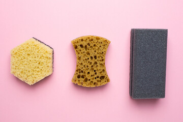 Set of housewives for washing dishes. Dishwasher. Bottle of washing utensils, sponges on pink background