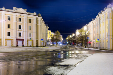 View of the historical center of the city of Magadan. Beautiful night city landscape. There is no one on the empty snowy streets. Magadan. Magadan region, Siberia, Far East of Russia.