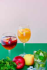 Fruit juice, delicious apple and citrus cocktail. Red and orange drink, fruit alcohol beverage.