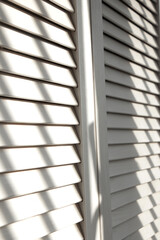 Contrasting shadows on classic white louvered doors. Wooden doors