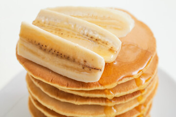 Tasty banana pancakes on plate, closeup