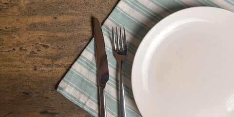 Vintage silverware on rustic wooden background. Top view of kitchen cutlery setting on grunge...