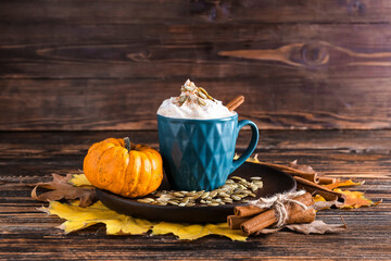 Cup of pumpkin cappuccino on table