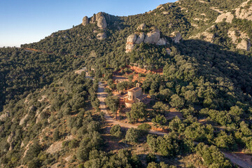 Aerial drone view of Holy Cave of Montserrat on mountain near Barcelona in sunrise