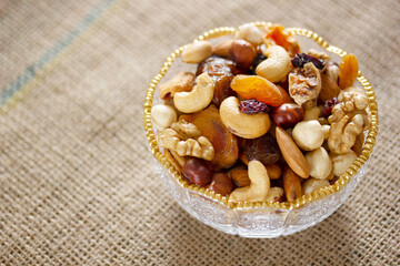 Mixed nuts in a glass plate. Healthy and natural nutrition .Cashew, Almond,, Hazelnut,, Fig,, Walnut,, Apricot,, Raisin,, Blueberry.