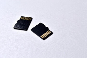two micro sd cards on a white plastic background. close-up.