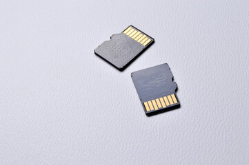 two micro sd cards on a white plastic background. close-up.