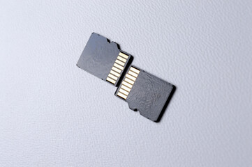 two micro sd cards on a white plastic background. close-up.