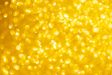 Abstract blurred glowing gold bokeh background, festive and season concept background