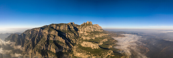 Panoramic aerial drone shot of Abbey Montserrat near Barcelona in mountain range in morning