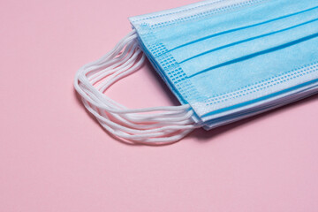 disposable masks on pink background