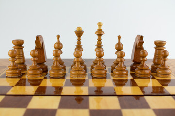 chessboard made of wooden pieces on white