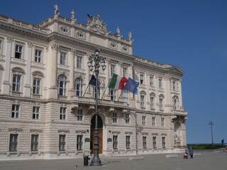 Fototapeta na wymiar Palace of Lloyd in Piazza Unità d'Italia in Trieste, decorated with allegorical statues on the ground floor and on the pediment