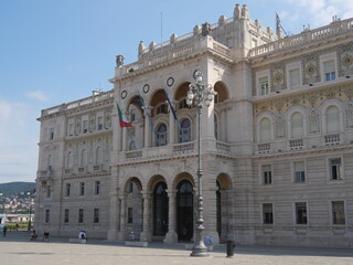 Fototapeta na wymiar Palace of the Austrian Lieutenancy in Piazza Unità d'Italia in Trieste, with the facade decorated with mosaics with the coats of arms of the Savoy house